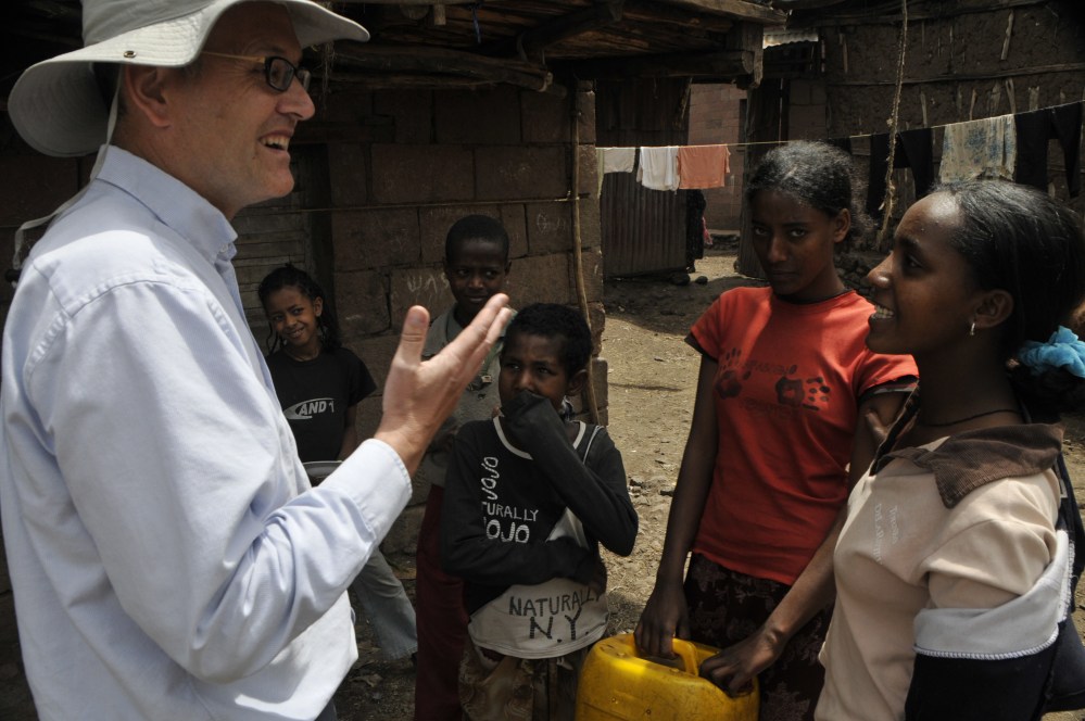 The late Dr Mark Goodwin talking to Ethiopian farmers and children 